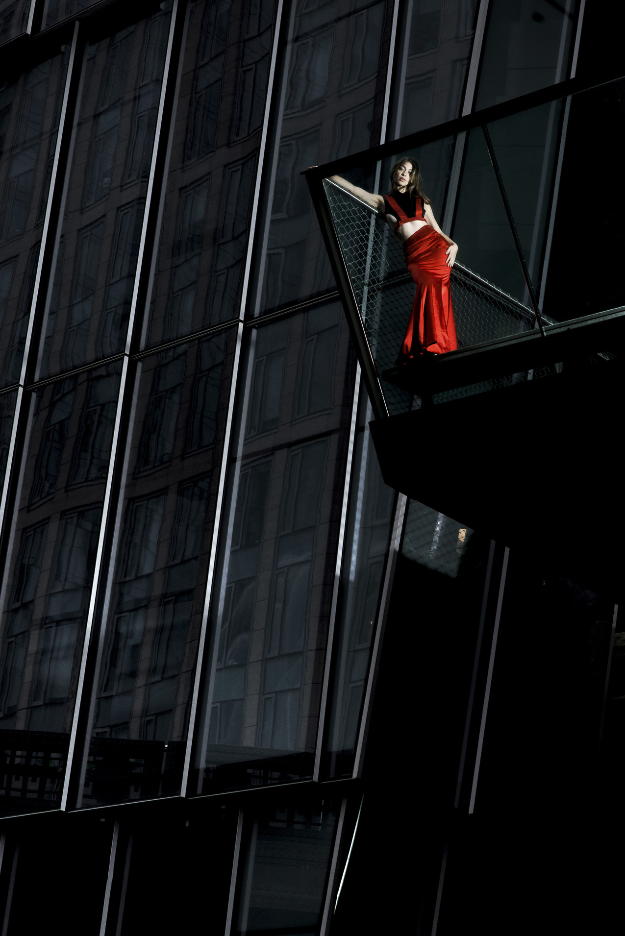 A woman standing outside in a red dress